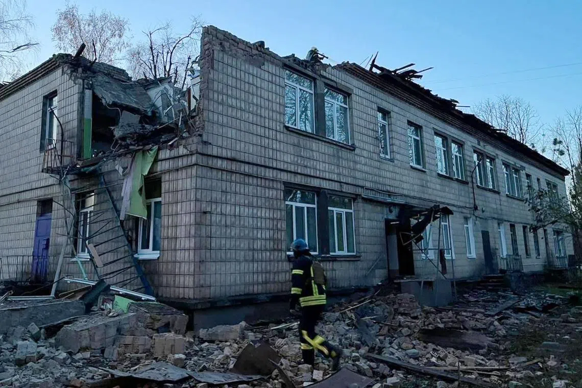 A rescuer working at the site of a drone attack in Kyiv on Nov 25.