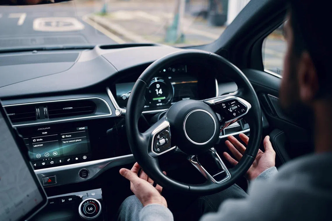 A driver with their hands off the wheel of a Wayve vehicle. The UK-based maker of AI systems for autonomous vehicles said that it had raised US$1 billion. 