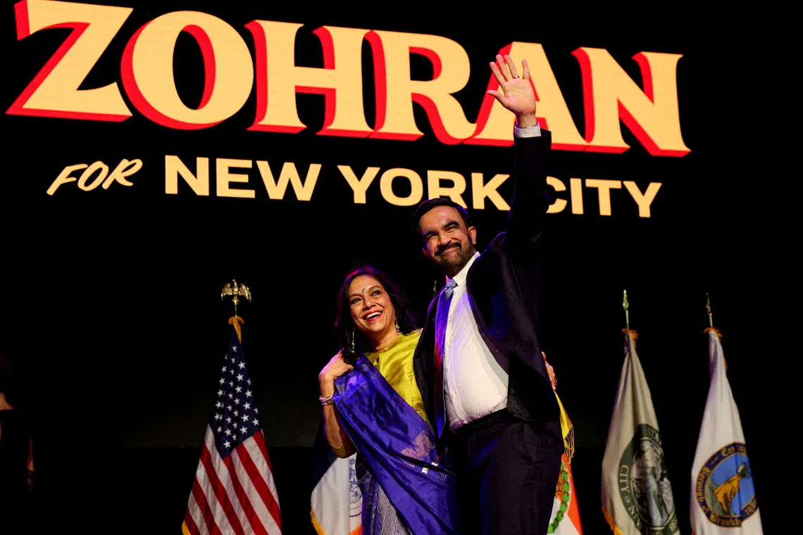 Democratic candidate for New York City mayor Zohran Mamdani waves next to his mother Mira Nair onstage after winning the 2025 New York City Mayoral race, at an election night rally in the Brooklyn borough of New York City, New York, U.S., November 4, 2025.  REUTERS/Shannon Stapleton