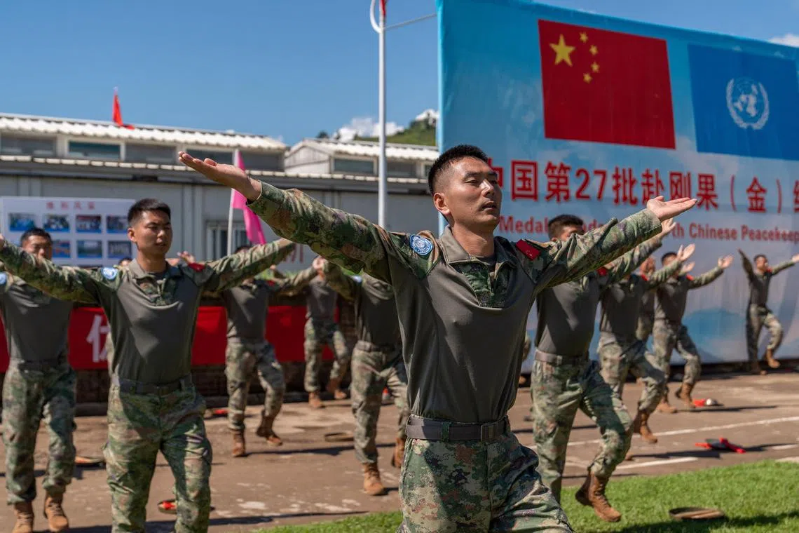 Chinese soldiers from the UN Organization Mission for the Stabilization of the Congo (MONUSCO) put on a show prior to their withdrawal from the Bukavu base in eastern Democratic Republic of Congo on Tuesday, April 09, 2024. Chinese peacekeepers with the UN stabilisation mission in eastern DR Congo attended a departure ceremony on April 9, 2024 as the force withdraws from the war-torn region.
The 15,000 MONUSCO troops deployed in the vast central African country started to leave in February at the request of the Kinshasa government, which considers them ineffective.
The disengagement is to be carried out in three phases this year. Under phase one, military and police peacekeepers from 14 bases in South Kivu are set to leave by the end of April. Civilian staff are to go by June 30. (Photo by Glody MURHABAZI / AFP)