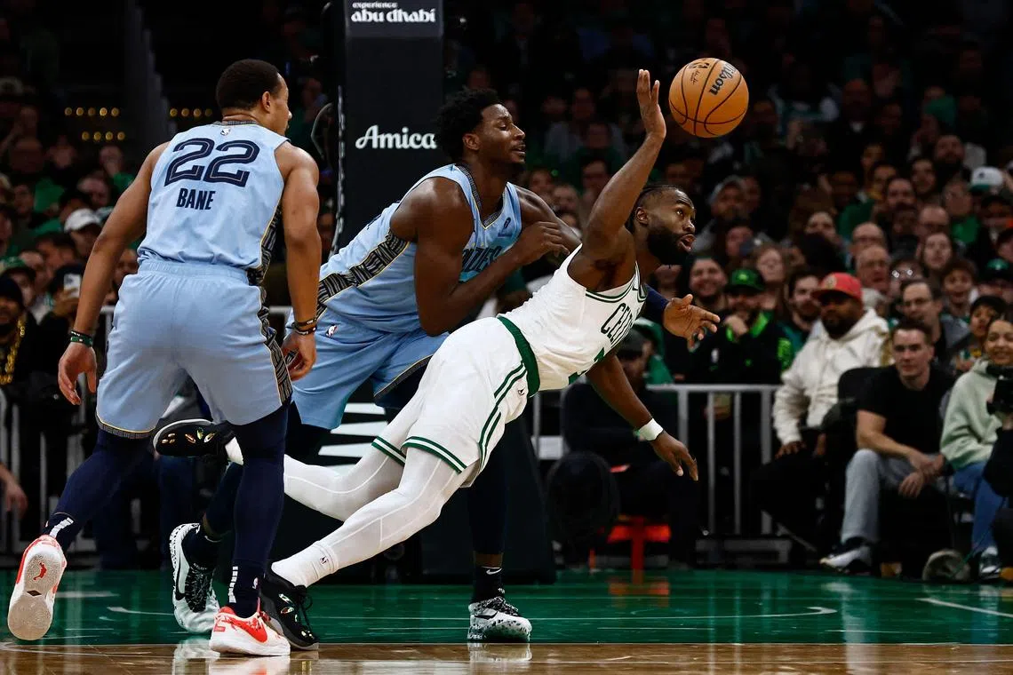 Jaylen Brown of the Boston Celtics reaches for a loose ball with Jaren Jackson Jr. of the Memphis Grizzlies during the second half at TD Garden on Dec 7.