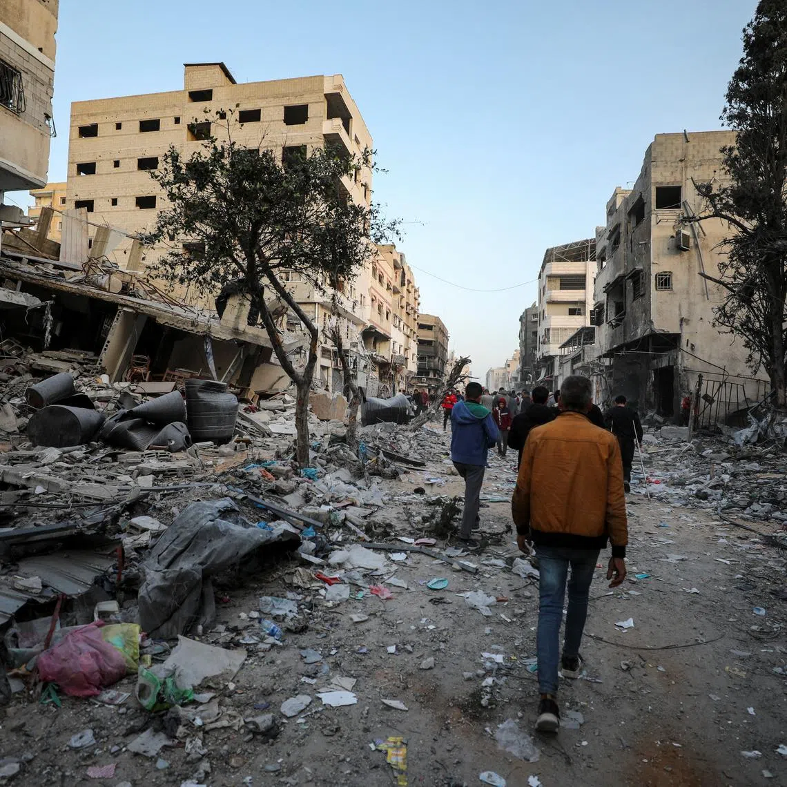 Palestinians inspect the damages at the area around Al Shifa Hospital following a two-week Israeli operation, amid the ongoing conflict between Israel and Hamas, in Gaza City April 1, 2024. REUTERS/Dawoud Abu Alkas
