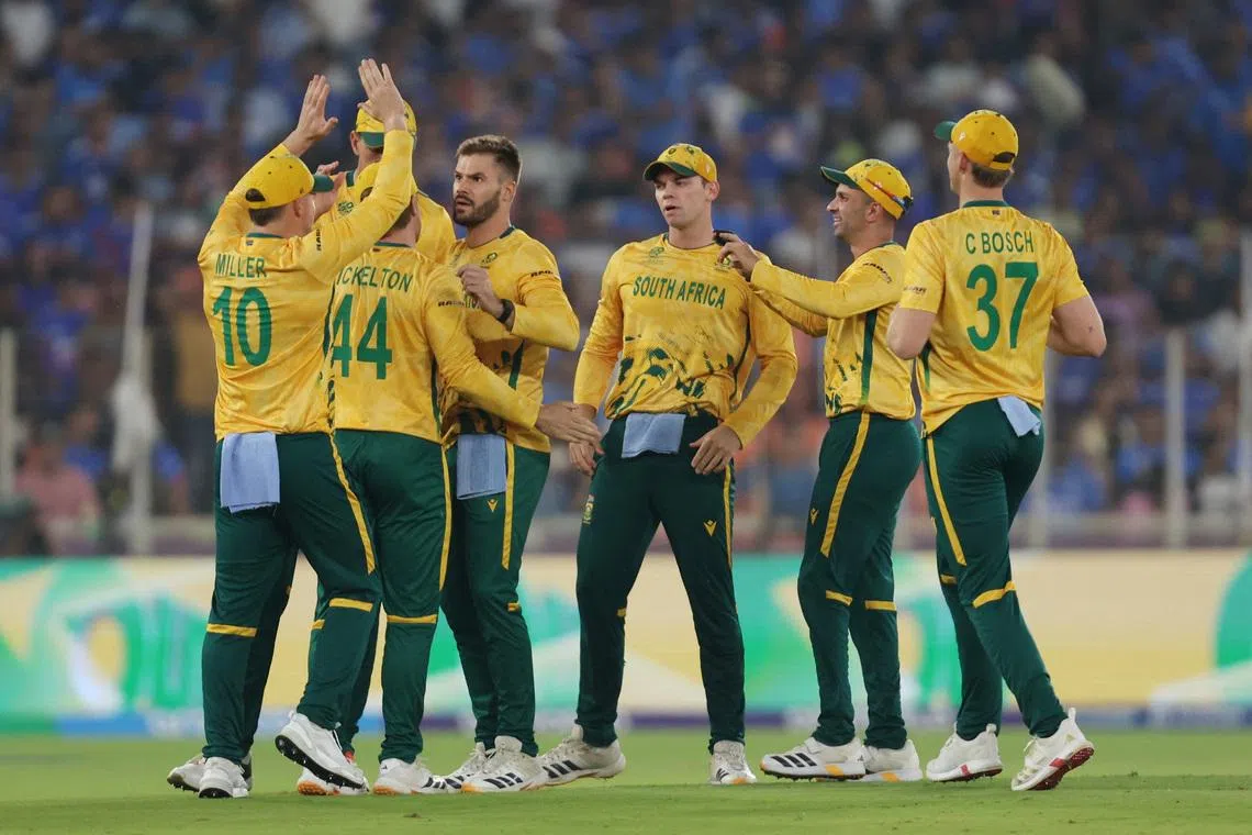 Cricket - ICC Men's T20 World Cup 2026 - Super 8 - India v South Africa - Narendra Modi Stadium, Ahmedabad, India - February 22, 2026 South Africa's Aiden Markram celebrates with teammates after taking the wicket of India's Ishan Kishan, caught out by Ryan Rickelton REUTERS/Amit Dave