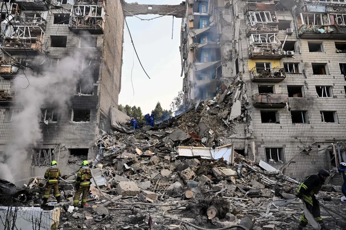 Ukrainian rescuers conduct a search and rescue work in a heavily damaged residential building following the Russian missile strike in Kyiv on June 17, 2025, amid the Russian invasion of Ukraine. Russian airstrikes on Ukraine's capital Kyiv early on June 17, killed at least one person -- a US citizen -- with 16 more injured, the city's mayor said. (Photo by Genya SAVILOV / AFP)