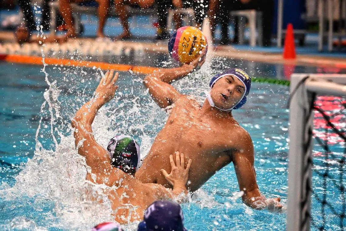 China’s Chen Zhongxian (right) scores against Iran in the final of the Asian Waterpolo Championship on March 27, 2023.