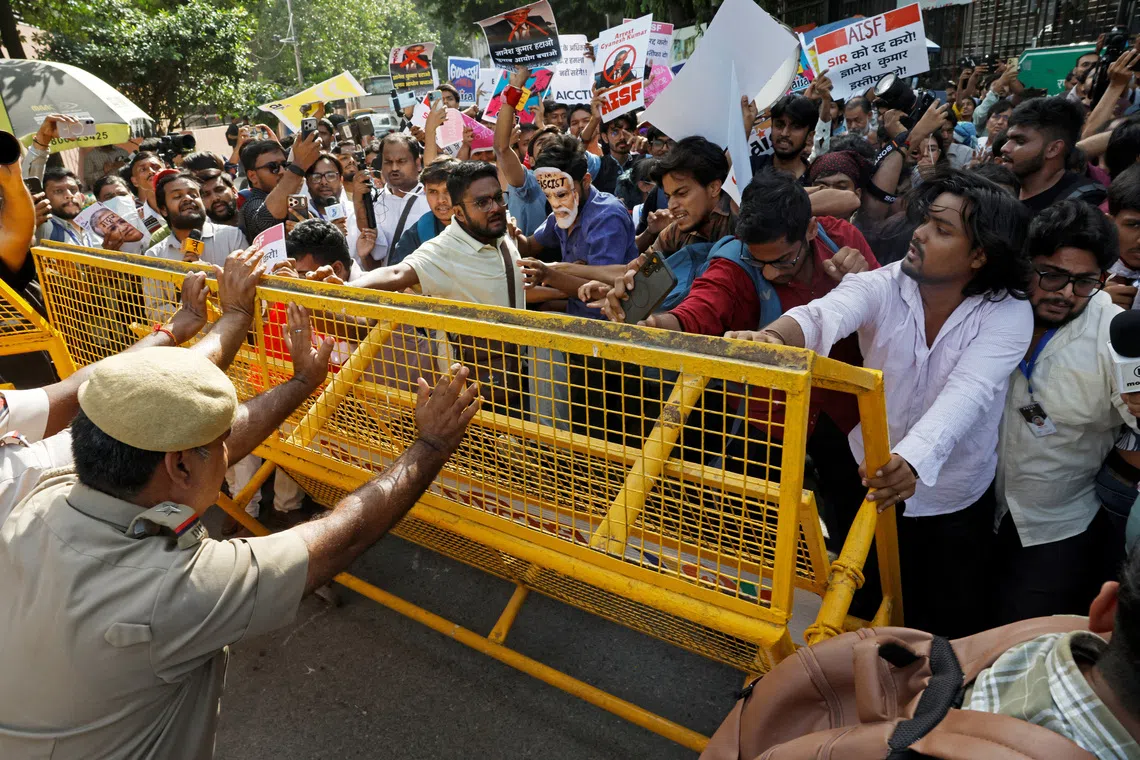 Demonstrators push against a police barricade during a protest demanding the resignation of India’s Chief Election Commissioner Gyanesh Kumar.