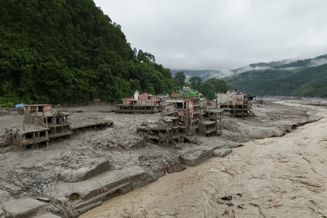 A drone view shows mud covering properties following a flash flood in Trishuli, Nuwakot district in Nepal on Aug 27.