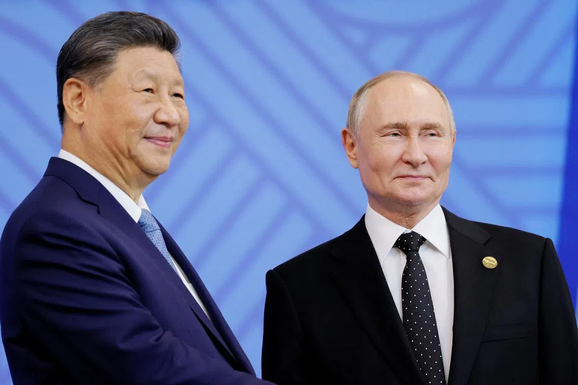Russian President Vladimir Putin (right) greets Chinese President Xi Jinping at the BRICS summit in Kazan, Russia on Oct 23.
