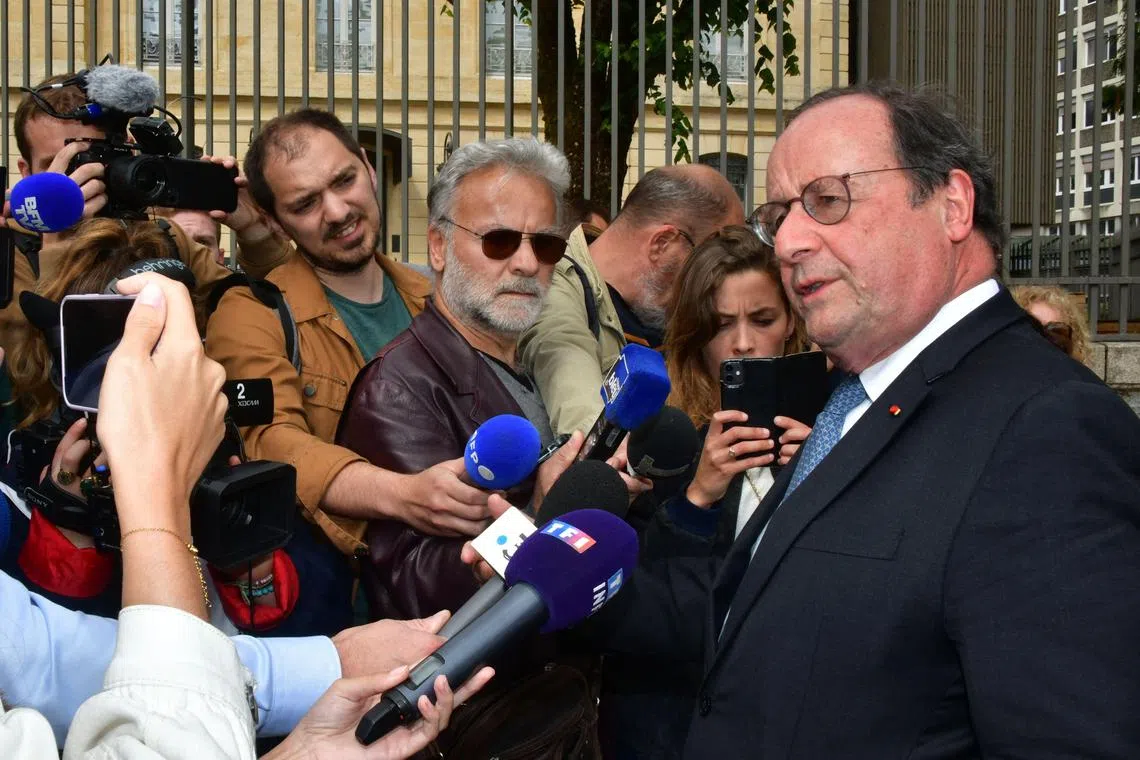 Former French president Francois Hollande (right) delivers a press conference to announce his candidacy in France's upcoming elections.