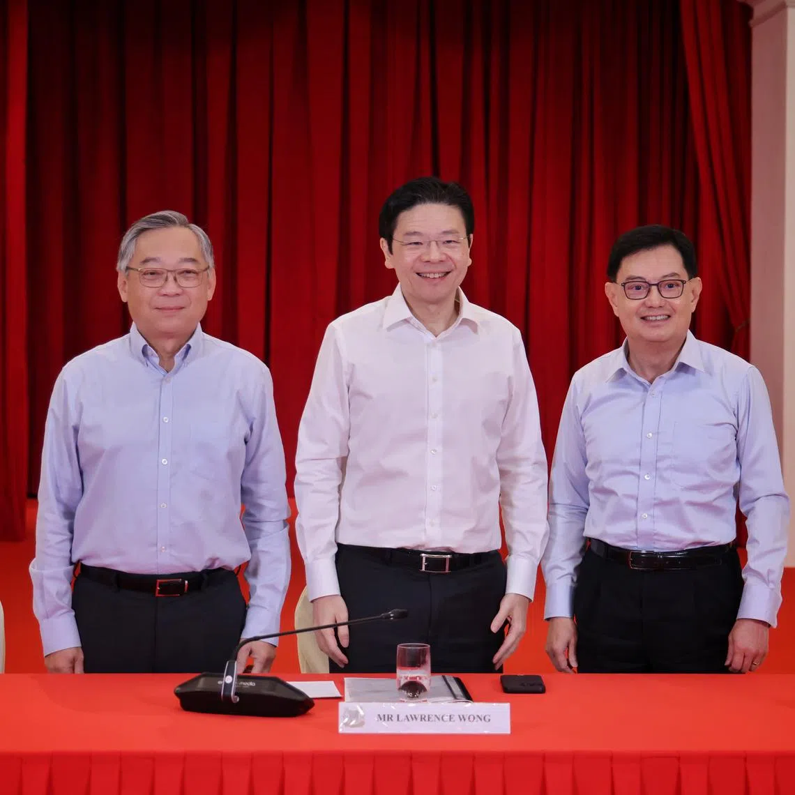 (From left) Minister for Trade and Industry Gan Kim Yong, DPM Lawrence Wong and DPM Heng Swee Keat pose at the Istana after a press conference.