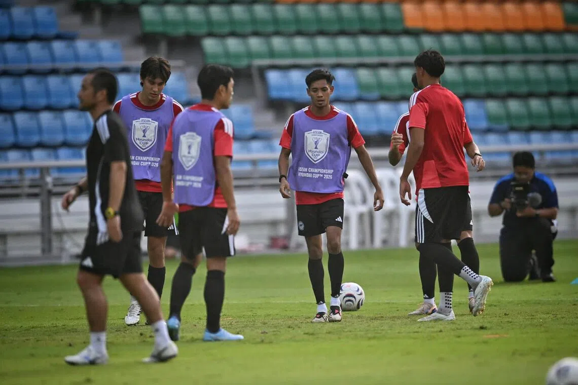 Singapore’s Shah Shahiran (centre) shows steely focus in training before the first leg of their ASEAN Championship semi-finals against Thailand.