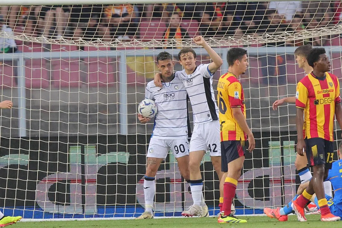 Atalanta's Gianluca Scamacca (left) celebrates with teammate Giorgio Scalvini after scoring against Lecce.