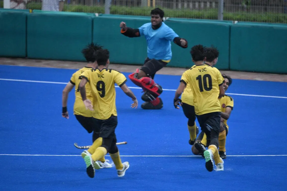 The team from Victoria Junior College, including goalkeeper T S Deyveekan (centre) celebrate after beating Raffles Institution in a penalty shoot out during the A Division boys' hockey final held at Sengkang Hockey Stadium on May 15, 2024.