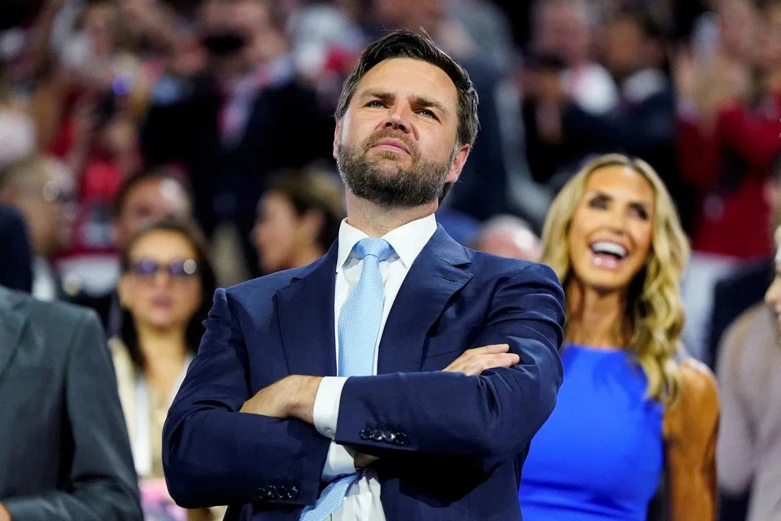 FILE PHOTO: Republican vice presidential nominee J.D. Vance, with RNC co-chair Lara Trump behind him, looks at the stage during Day 1 of the Republican National Convention (RNC), at the Fiserv Forum in Milwaukee, Wisconsin, U.S., July 15, 2024. REUTERS/Elizabeth Frantz/File Photo
