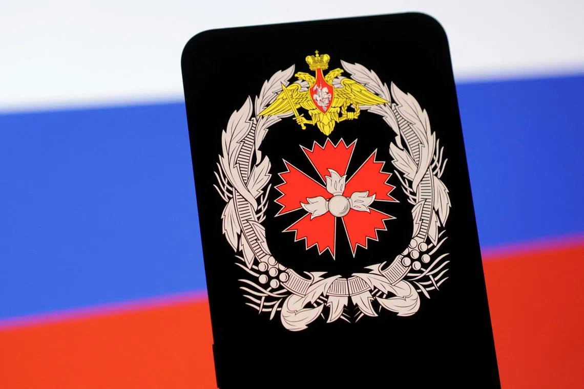 GRU (Russia's military intelligence agency) logo and Russian flag are seen in this illustration taken May 6, 2025. REUTERS/Dado Ruvic/Illustration