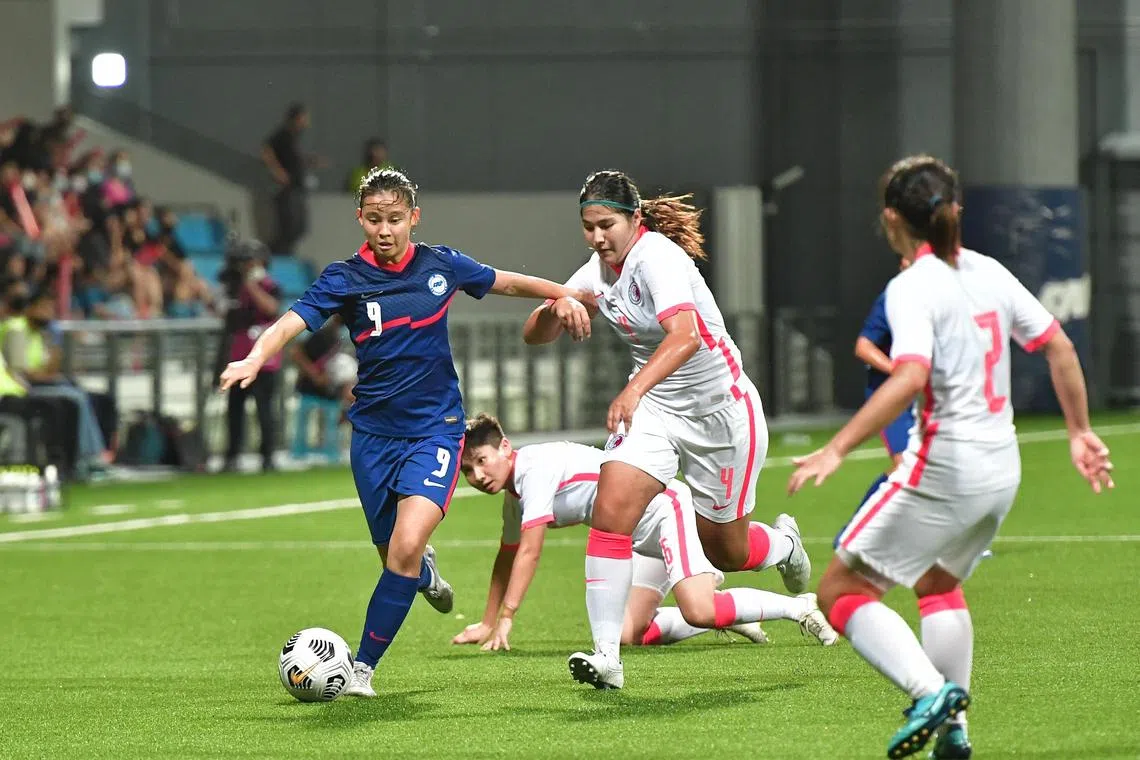 Singapore forward Danelle Tan trying to get past Hong Kong defender Hui Yee Sum at a friendly match held at the Jalan Besar Stadium on 26 Jun 2022. The 1-0 loss to the visitors was a much improved showing from the 4-0 defeat earlier.

ST FILE PHOTO