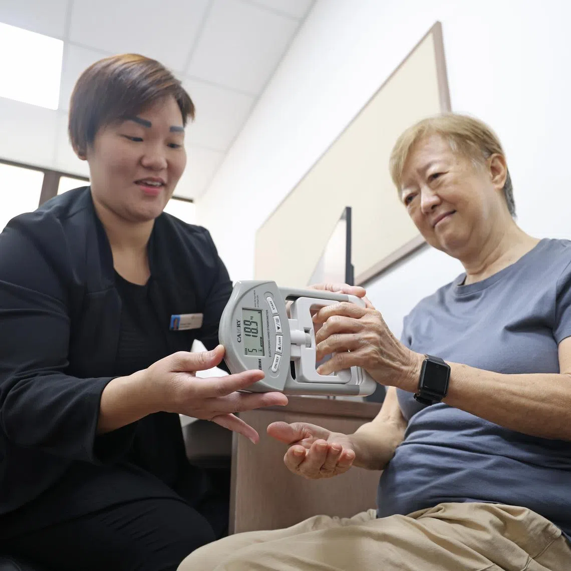 Under the supervision of Ms Doreen Chan, Senior Care Coordinator, Nursing Services, NHG Polyclinics, Ms Doris Yam, doing the hand grip test, one of the many test done under the frailty programme. A hand grip reading of 18 and above is considered to be ideal for women.


