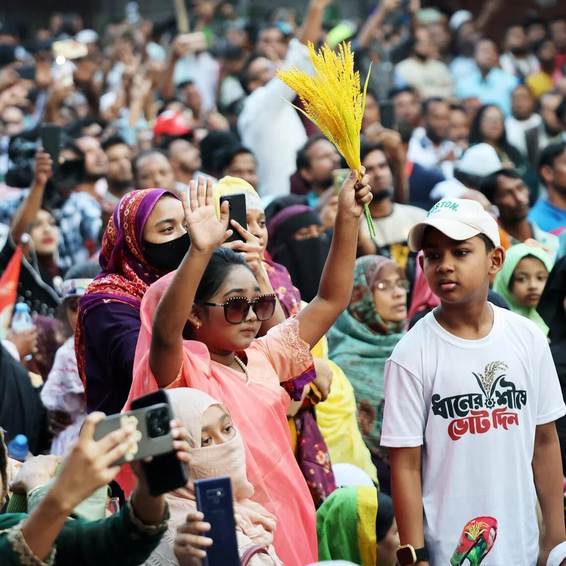 Supporters of Bangladesh Nationalist Party (BNP) wave as they attend an election campaign rally for party chairman Tarique Rahman, ahead of the national election in Dhaka on Feb 9, 2026.
