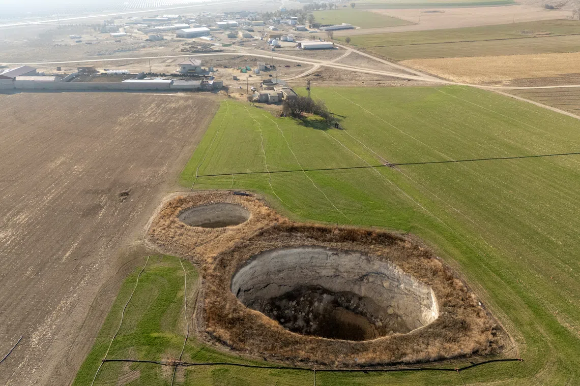 A drone view shows sinkholes formed in the middle of a farmland in Konya province, Turkey, December 18, 2025. REUTERS/Umit Bektas