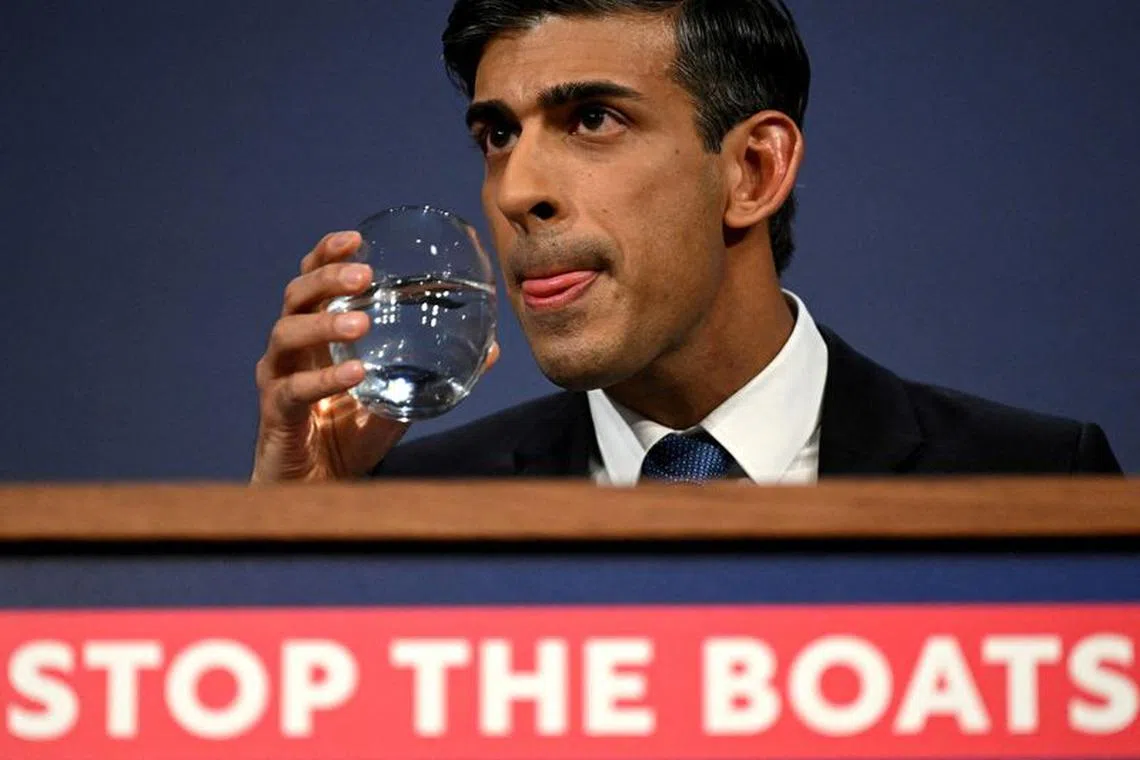 British Prime Minister Rishi Sunak drinks water during a press conference following the launch of new legislation on migrant channel crossings at Downing Street on March 7, 2023 in London, United Kingdom. Leon Neal/Pool via REUTERS/File Photo