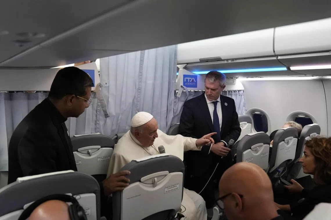 Pope Francis (centre) addressing journalists on board an airplane on his flight back from Marseille to Rome on Saturday.