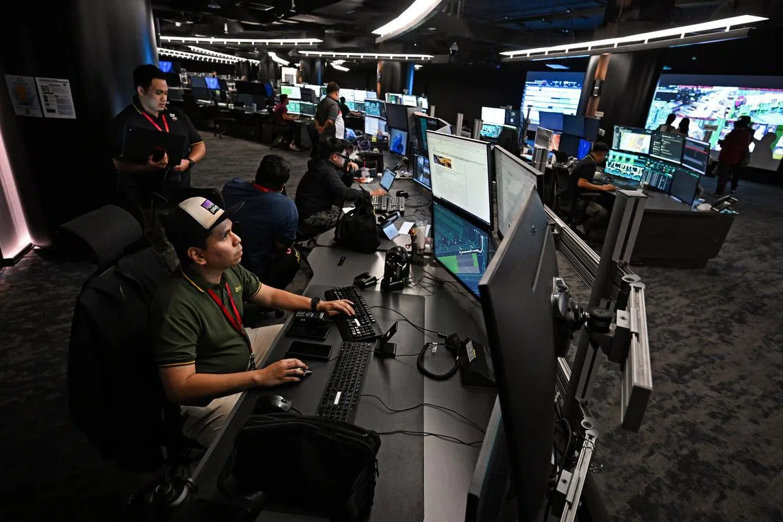 Image 9: Operations staff working inside the control centre at PSA Tuas Port on Oct 21, 2025.  Automated equipment and integrated operations systems will be deployed to operate the next generation ports.