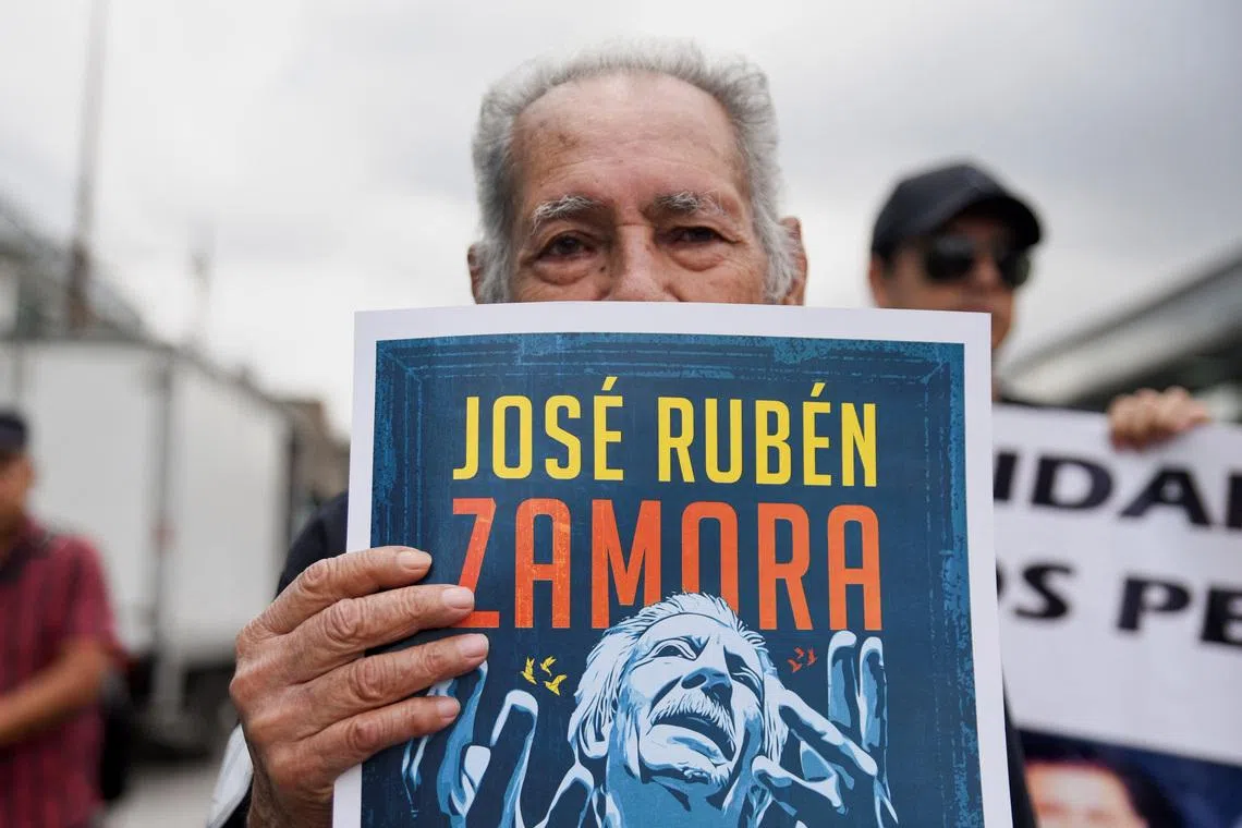 A man holds a sign with an image depicting journalist Jose Ruben Zamora during a protest to demand his release from jail, in Guatemala City, Guatemala, September 18, 2025. REUTERS/Cristina Chiquin/File Photo