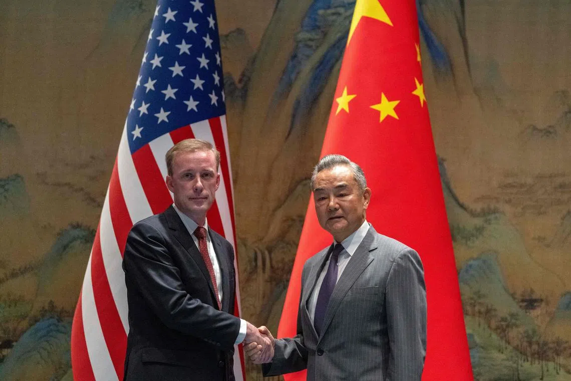 China's Foreign Minister Wang Yi (R) shakes hands with US National Security Advisor Jake Sullivan at Yanqi Lake in Beijing on August 27, 2024. (Photo by Ng Han Guan / POOL / AFP)