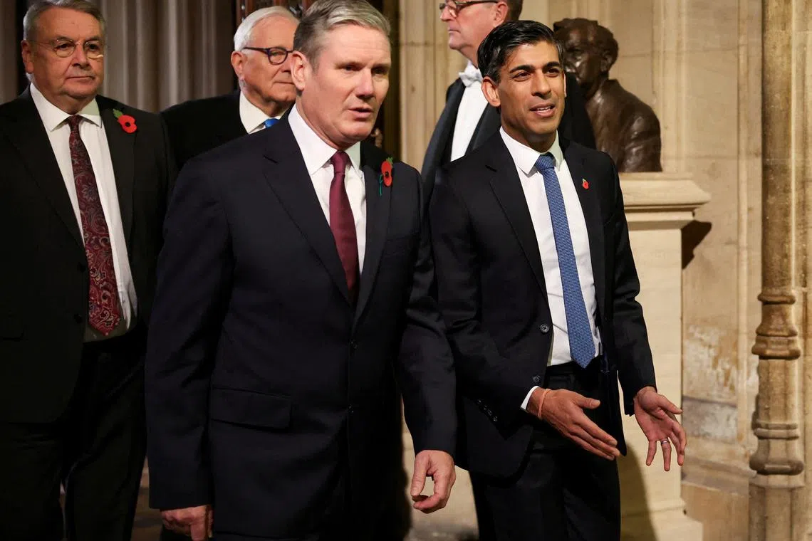 Labour Party leader Keir Starmer (left) walks with Britain's Prime Minister Rishi Sunak during the State Opening of Parliament ceremony.