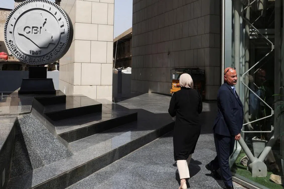 Employees walk at the headquarters of the Central Bank of Iraq in Baghdad, Iraq August 15, 2023. REUTERS/Ahmed Saad/File photo