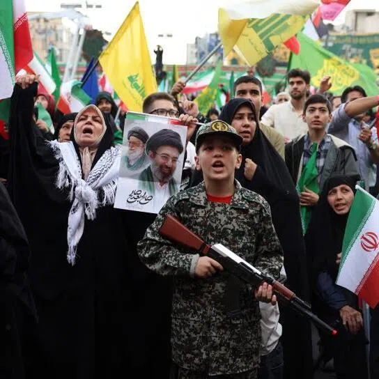 A young enthusiast dressed in military attire holding a mock rifle at a rally in support of the Iran's Supreme Leader Ayatollah Mojataba Khamenei in Tehran, on April 29.