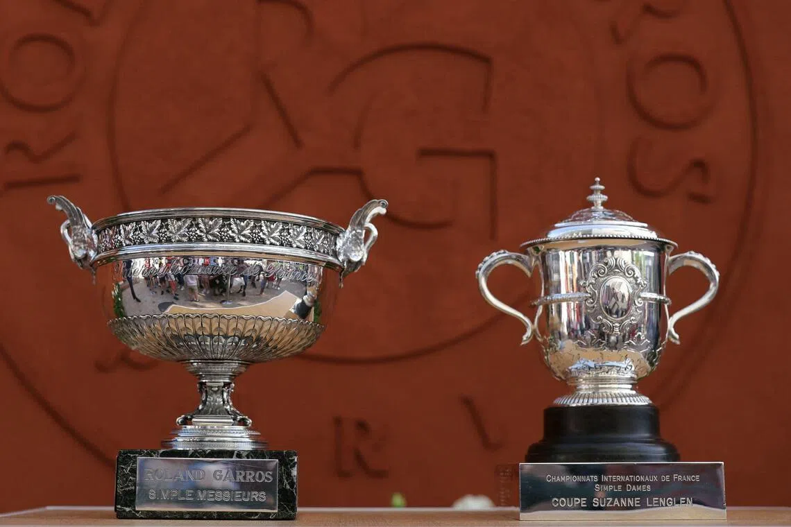 The French Open men's singles trophy, the Musketeers’ Cup (left), and the women's singles trophy, the Suzanne-Lenglen Cup, on display at the Roland-Garros Complex in Paris on May 23, 2026.