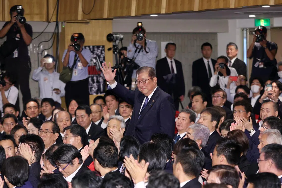 Mr Shigeru Ishiba waves to his Liberal Democratic Party (LDP) colleagues after he won a ruling party leadership election on Sept 27, 2024.