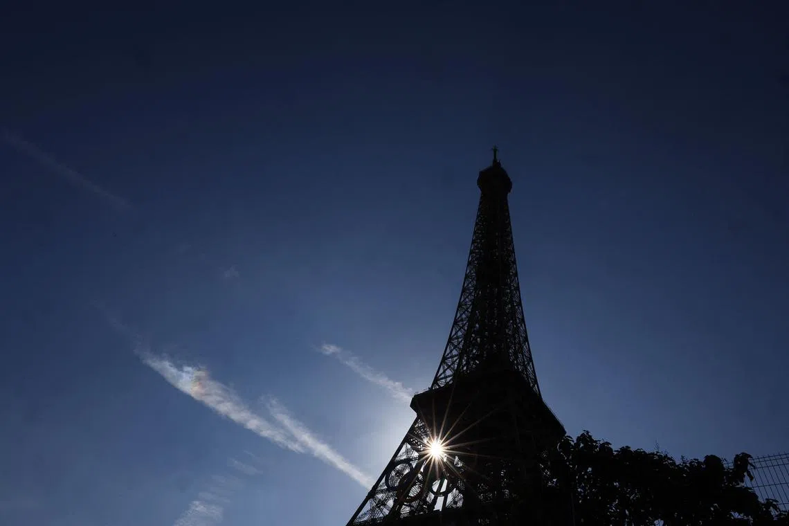 Paris 2024 Olympics - Paris, France - July 28, 2024 Sunlight shines through the Olympic Rings on the Eiffel Tower during the Olympics REUTERS/Kai Pfaffenbach