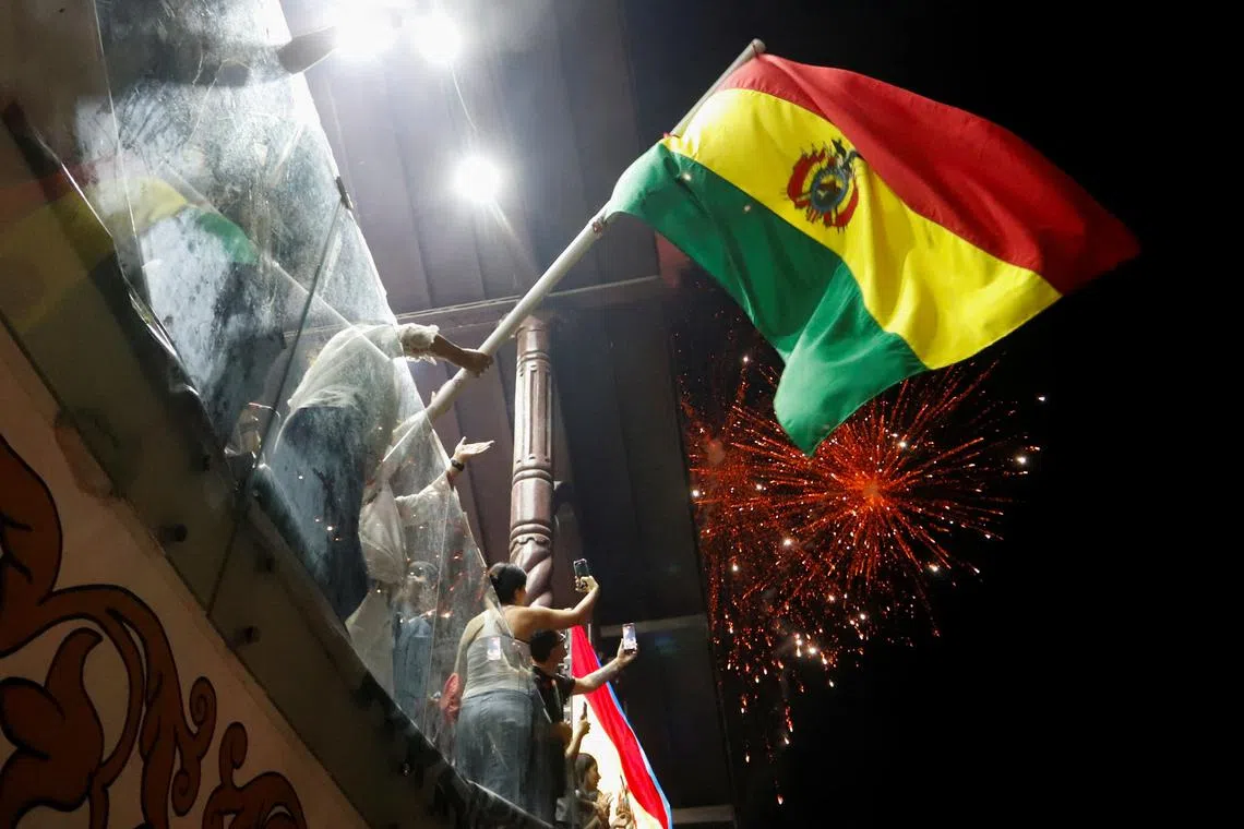 FILE PHOTO: People celebrate after early official results show Bolivian presidential candidate Jorge \"Tuto\" Quiroga of the conservative Alianza Libre coalition in second place, and as the ruling party Movement for Socialism (MAS) was on track to suffer its worst electoral defeat in a generation, in Santa Cruz, Bolivia, August 17, 2025. REUTERS/Ipa Ibanez/File Photo