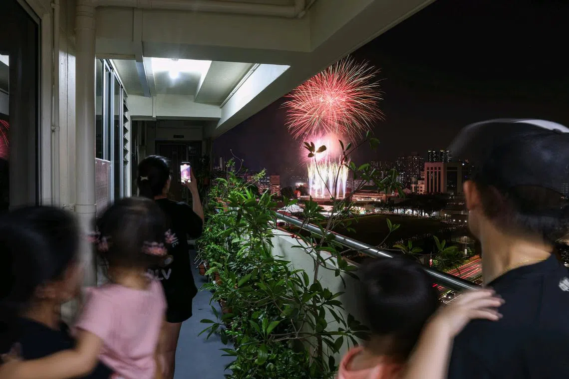 A family watching fireworks in Bishan on Aug 10.