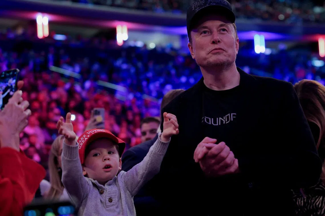 Tesla CEO and X owner Elon Musk stands next to his son during a rally for Republican presidential nominee and former US president Donald Trump at Madison Square Garden in New York on Oct 27, 2024. 