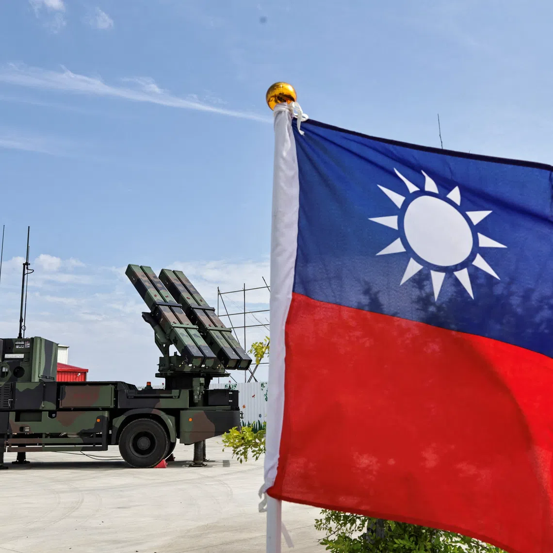 A Taiwanese flag flutters near a Land-Based TC-2 surface-to-air missile launch vehicle during a short-range air defense drill as part of the annual Han Kuang military exercise, in Taoyuan, Taiwan, August 8, 2026. REUTERS/Cheng-Chia Huang/File Photo