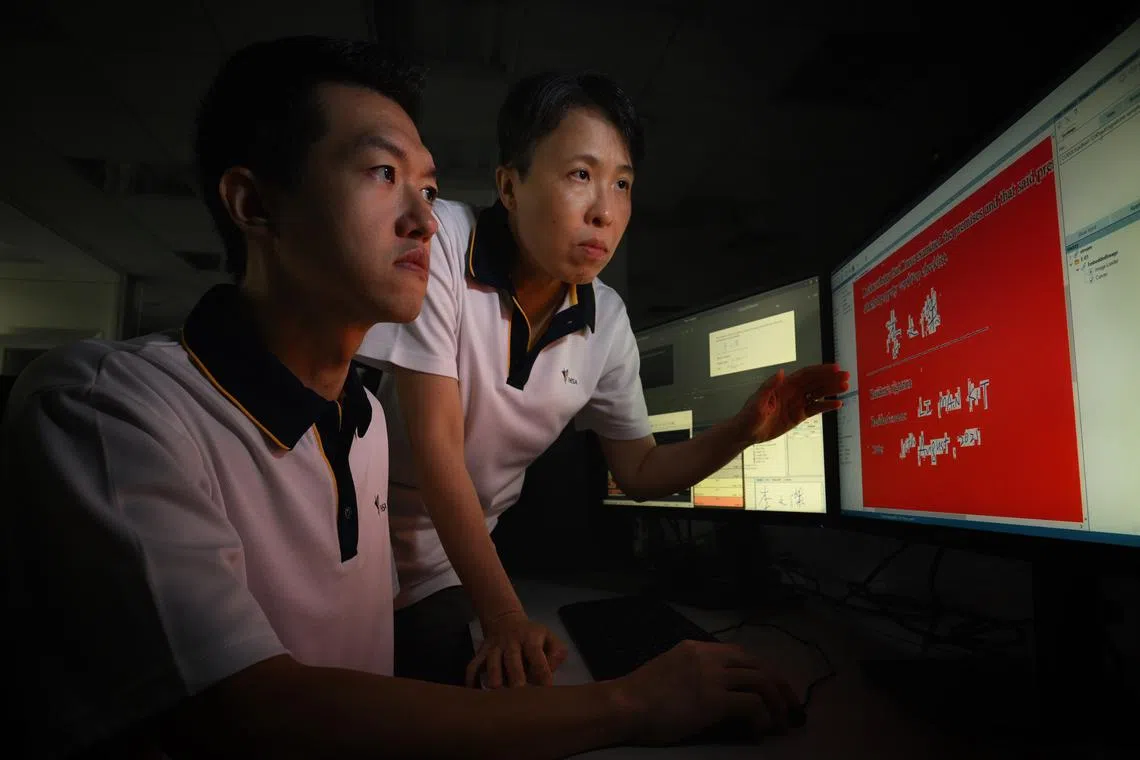 Louis Koh (left) and Nellie Cheng from the Forensic Chemistry & Physics Laboratory at work on Sept 3, 2024.