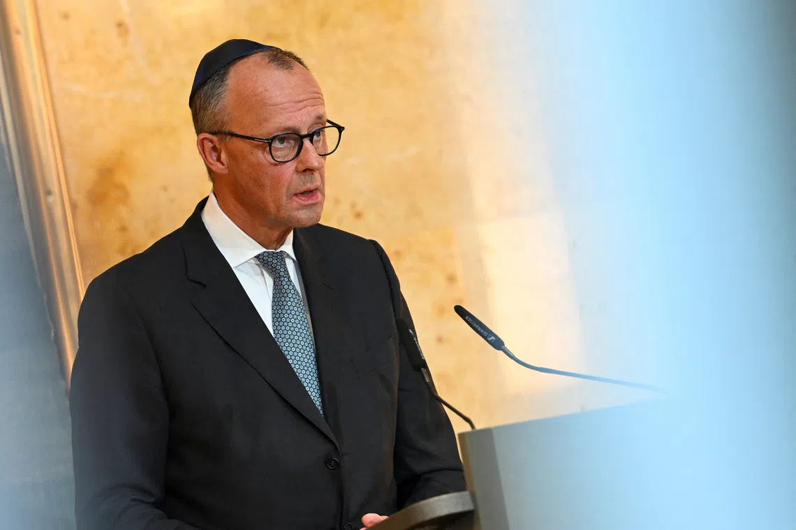 FILE PHOTO: German Chancellor Friedrich Merz attends celebrations of the newly completed renovation of Reichenbach Strasse synagogue in Munich, Germany, September 15, 2025. REUTERS/Angelika Warmuth/File Photo
