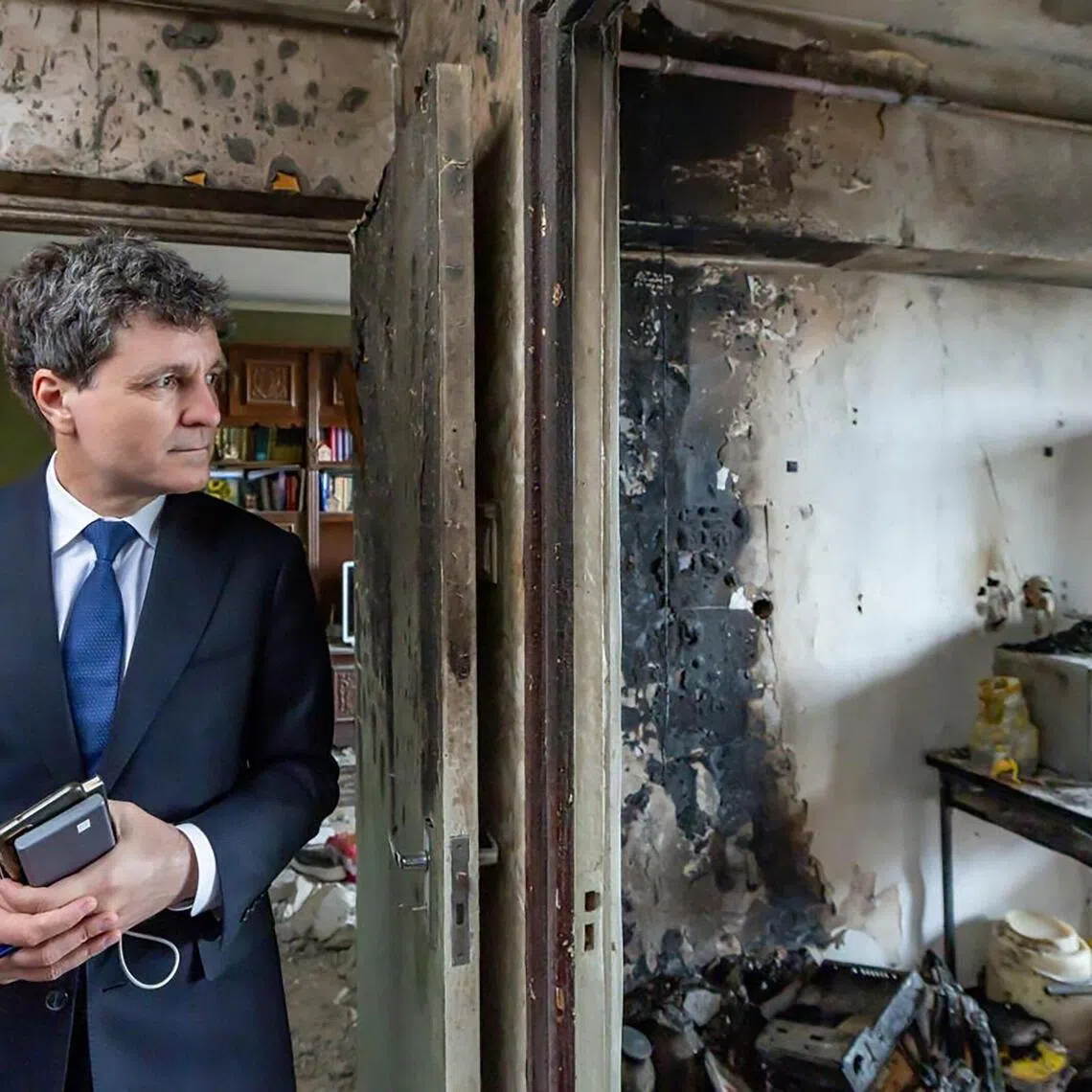 Romania's President Nicusor Dan visiting the apartment block that was struck by a drone wounding two people in Galati. 