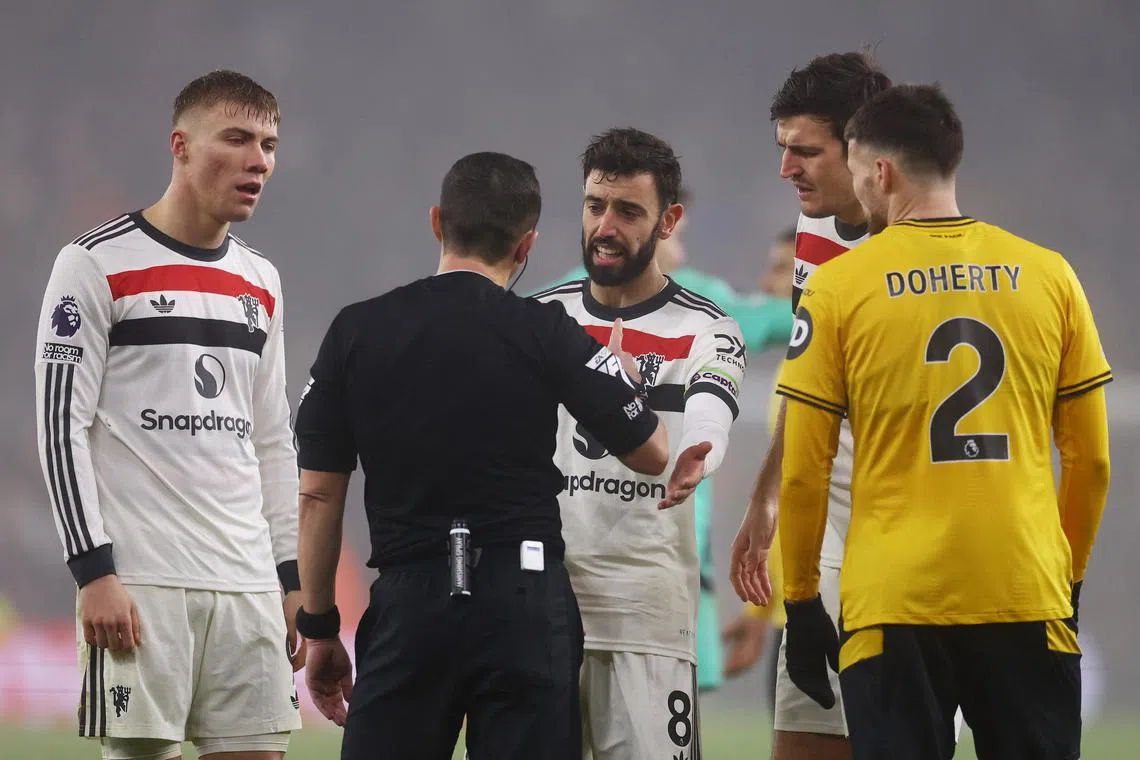 Manchester United's Bruno Fernandes talking to referee Tony Harrington on Dec 26, before being shown a red card.