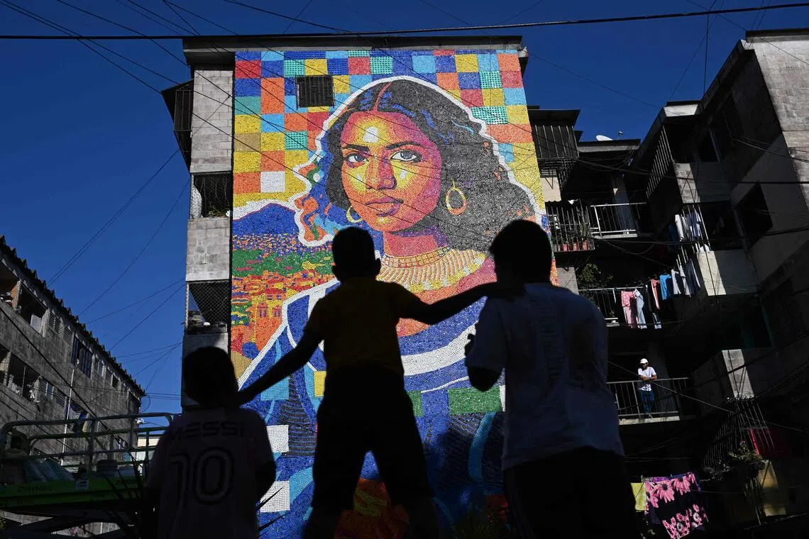 A mural made with plastic bottle caps by Venezuelan artist Oscar Olivares on an apartment building in the Zacamil neighbourhood in El Salvador.