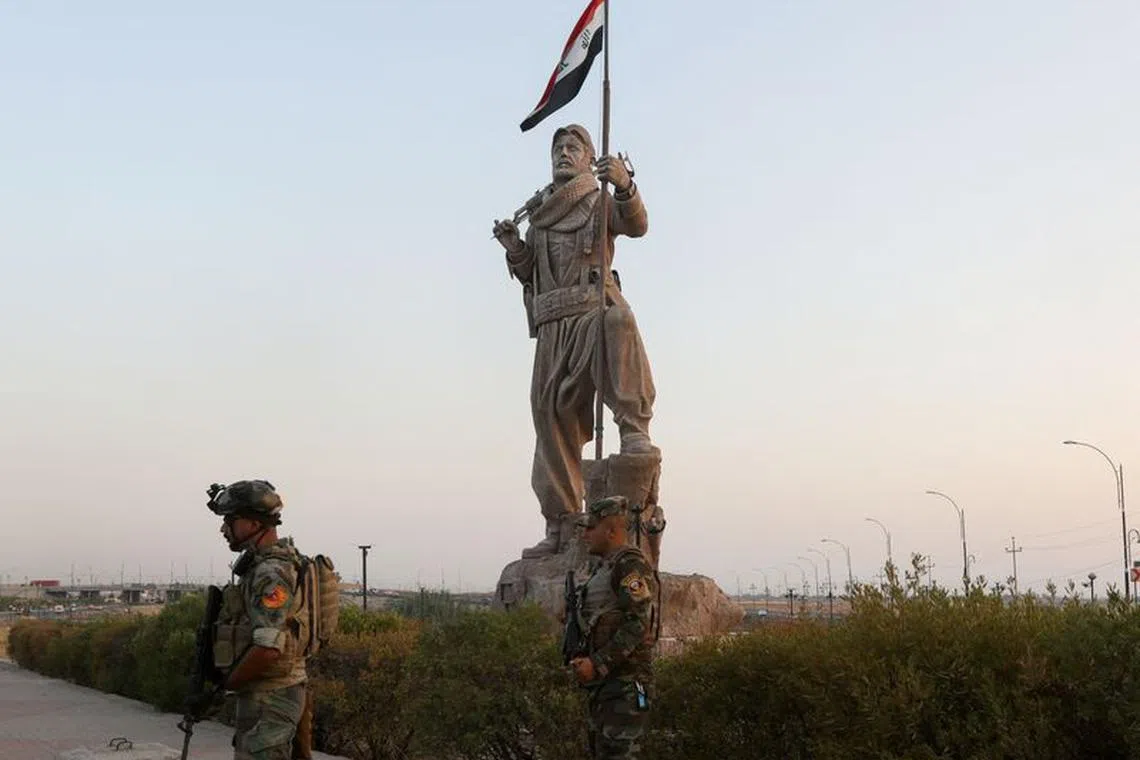 FILE PHOTO: Iraqi security forces stand guard near the Peshmerga statue following violent clashes between ethnic groups, in Kirkuk, Iraq, September 5, 2023. REUTERS/Ako Rasheed