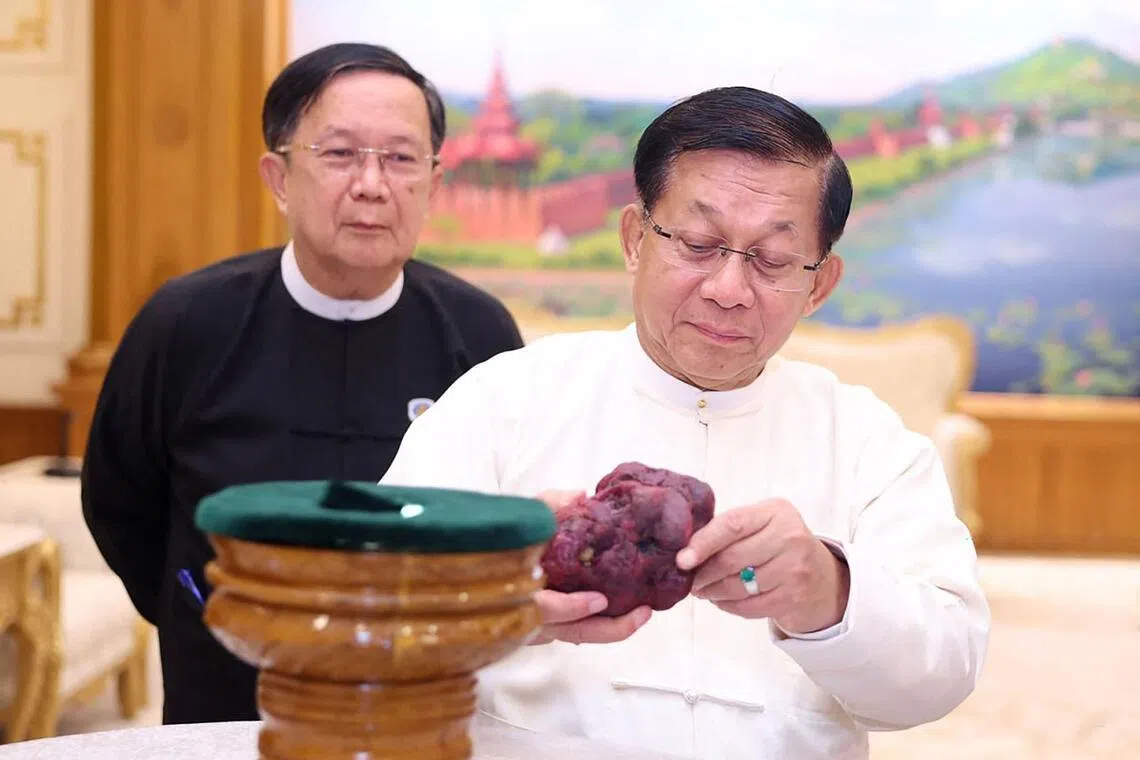 Myanmar’s coup leader turned president Min Aung Hlaing holding an 11,000-carat ruby in Naypyitaw, after it was found at a gem tract in Mogok in Mandalay. 