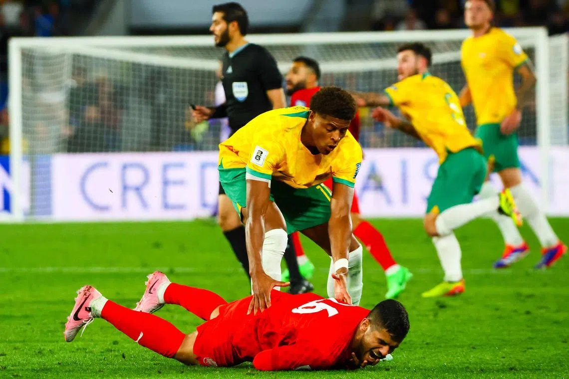 Australia's Kusini Yengi trying to assist Bahrain's Sayed Baqer after fouling him in the 2026 World Cup AFC qualifier at Cbus Super Stadium on the Gold Coast on Sept 5, 2024.
