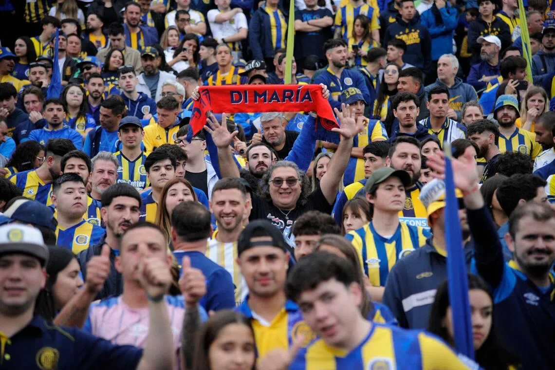 A fan of Rosario Central forward Angel di Maria cheers for him before a match.