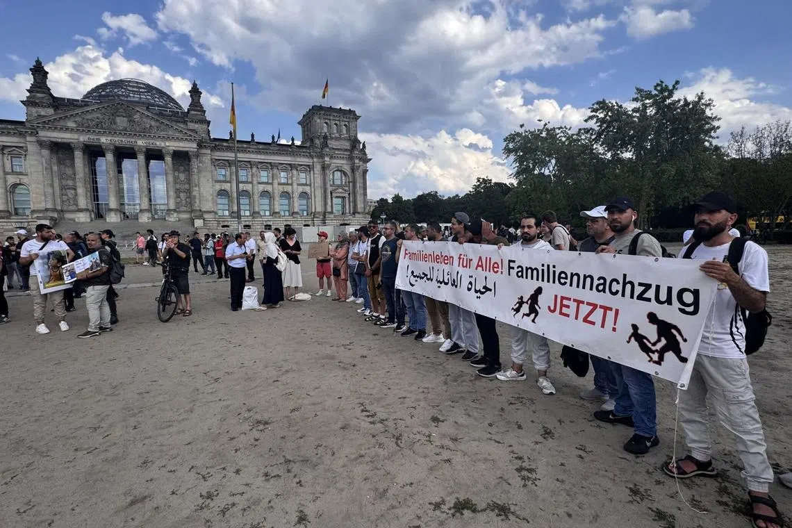 People protesting against a bill suspending family reunification for refugees with subsidiary protection status in front of the Reichstag in Berlin on June 26.