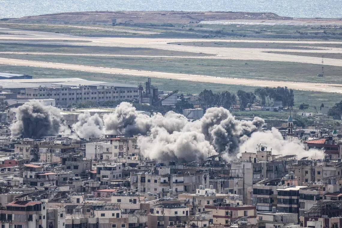 Smoke rises following Israeli airstrikes in Beirut's southern suburbs, with the capital's international airport visible in the background, on April 8, 2026. 