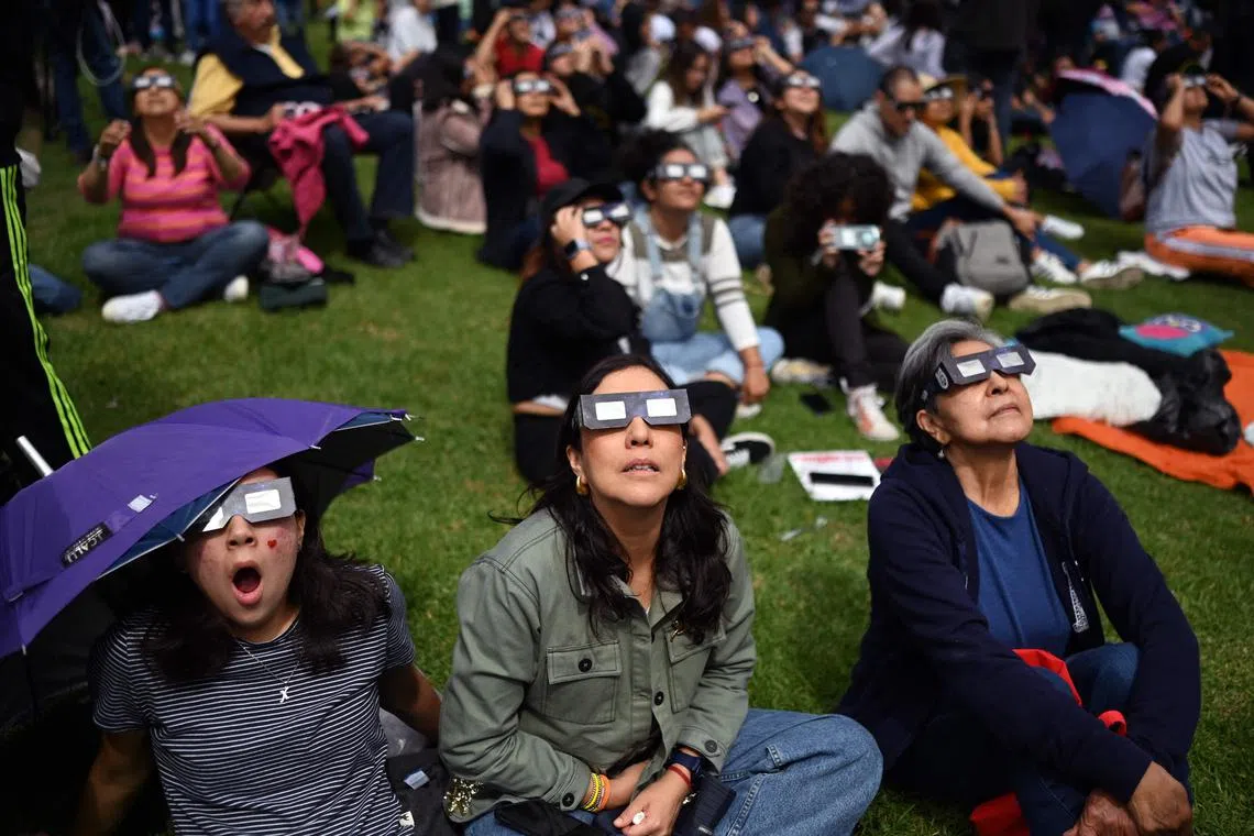 People watching the annular solar eclipse at the Luis Enrique Erro Planetarium of the National Polytechnic Institute (IPN) in Mexico City on Oct 14, 2023. 
